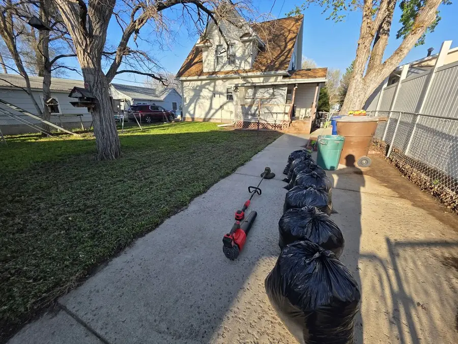 Bags of raked leaves lined up along a path after a fall cleanup
