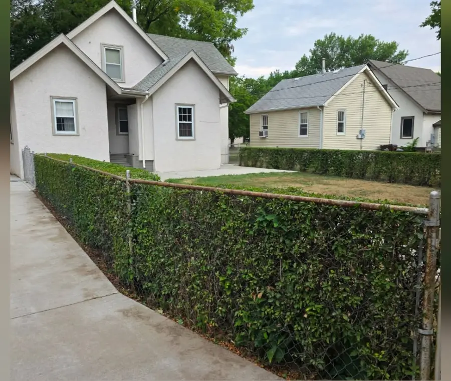 The same hedge squared off flat and straight, after trimming