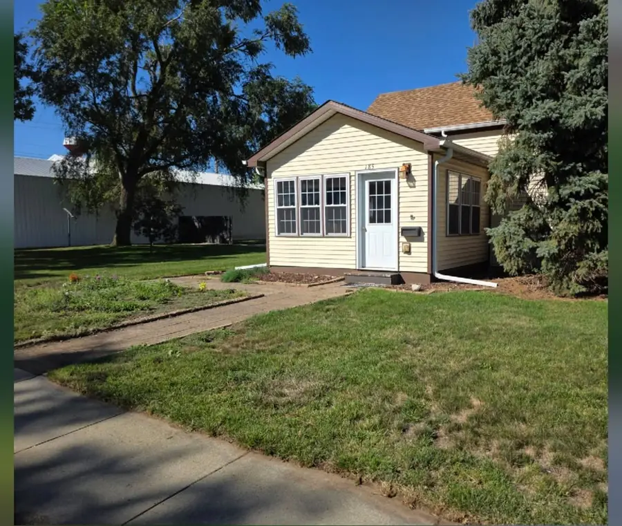 The same front yard mown short and tidy, after OH Lawn Care